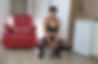 Black dildo and red leather chair